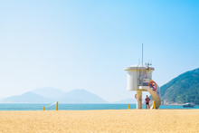 Lifeguard Under Tower On The Beach View Of Blue Sea And Mountain