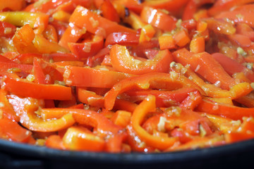 Sweet pepper with onions in a frying pan.