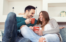 Cute Young Couple Drinking Coffee At Home