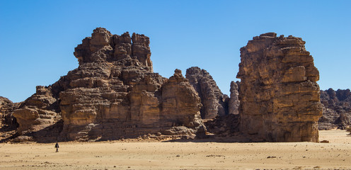 Wall Mural - Tuareg walking in the rocky algerian desert of Tassili N'ajjer