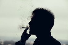Man Smoking A Cigarette. Silhouette