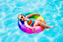 Child With Toy Ring In Swimming Pool