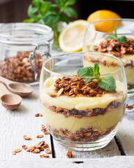 Wall Mural - Healthy dessert in a glass with lemon cream and granola