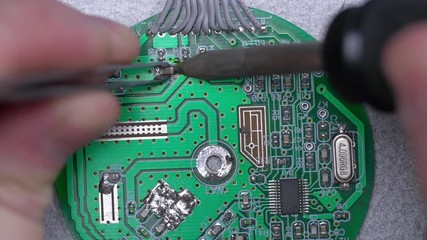 Poster - Microcircuit being fixed with soldering iron. Computer repair concept. Tweezers with chip and soldering Iron. soldering iron and microcircuit. microcircuit, microchip, integrated circuit