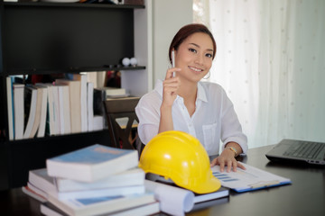 Female engineers are thinking to create new jobs and are smiling and working happy