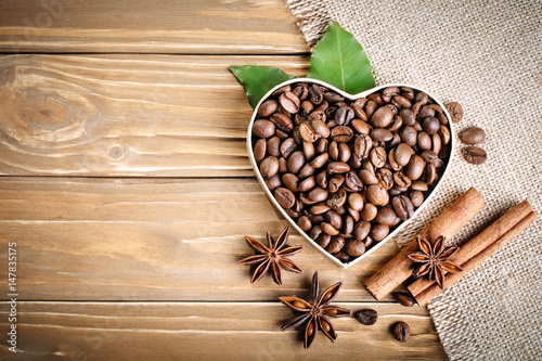 fried-coffee-beans-lie-in-the-form-of-heart-on-wooden-boards-and-burlap