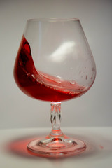 A glass of red wine in motion