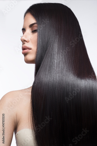 Fotografering Beautiful brunette girl in move with a perfectly smooth hair, and classic make-up