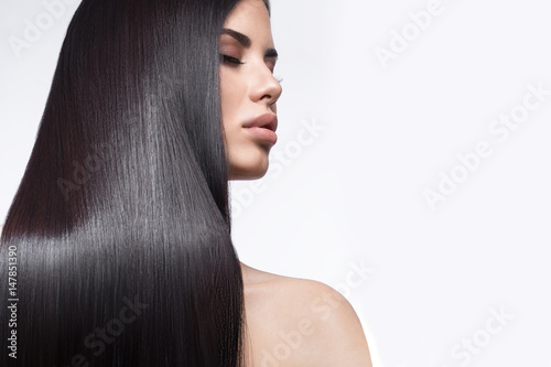 Beautiful brunette girl in move with a perfectly smooth hair, and classic make-up Wallpaper Mural