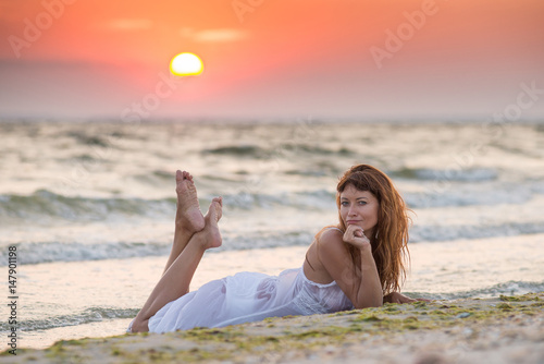 On The Beach At Sunset In White Dress On The Beach At Sunset In White Dress