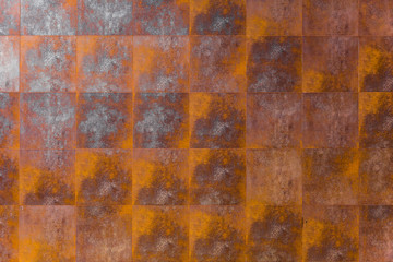 rusty metal tile wall. steel iron wallpaper for industrial texture pattern background.