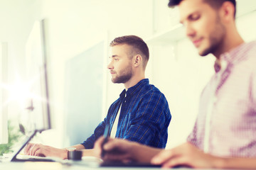 creative man or student with computer at office