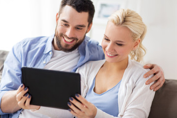 Poster - smiling happy couple with tablet pc at home