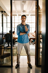 Wall Mural - Creative young man standing in doorway