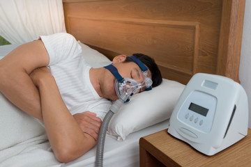 Sweet dream during long deep sleep.Continuous positive airway pressure  ,CPAP sleep apnea therapy.Happy and healthy senior man  breathing more easily during sleep without snoring .