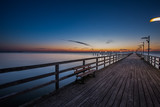 Fototapeta Pomosty - Wooden pier in Mechelinki. Small fishing village in Poland. Amazing Sunrise at the beach