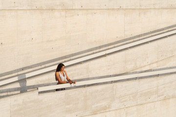 Wall Mural - Tired woman taking a workout rest for drinking water during outdoor running and fitness workout.