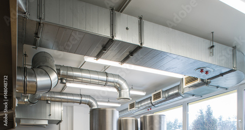 Fotomural Ventilation pipe system in kitchen interior.