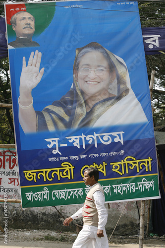 Man Walks In Front Of Poster Of Bangladesh Awami League President