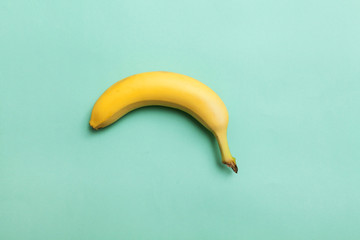 ripe banana on a background of mint color