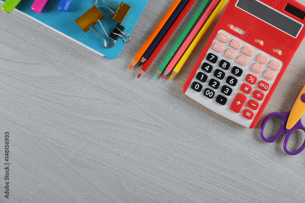 Notebook and different stationery on wooden background