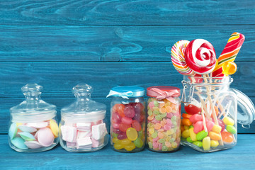 Canvas Print - Composition of different candies on wooden background