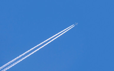 Wall Mural - diagonal trace of plane flying in blue sky