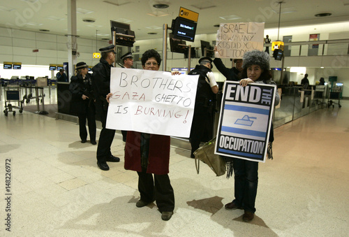 Israeli Protestors Hold Placards Near The El Al Check In Desk At