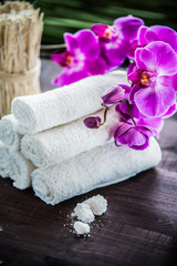 Accessories for spa.  White towels, orchid and stones for spa