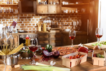 pizza, wine and vegetables ready for party