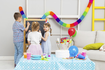 Happy group of children having fun at birthday party. Happy birthday