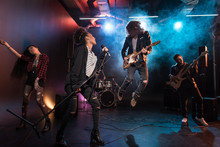 Young Multiethnic Rock And Roll Band Performing Hard Rock Music On Stage