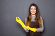 © F8  \ Suport Ukraine - Young smile woman wearing rubber gloves on grey background