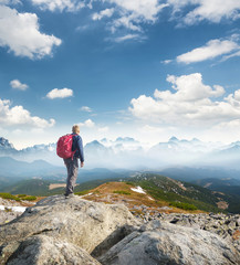 Wall Mural - tourist on the mountain top. sport and active life concept in the summer time