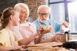 © LIGHTFIELD STUDIOS - Family kneading dough