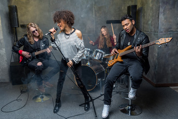 young rock band rehearsing in musical studio, band on stage concept