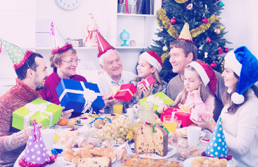 Large family handing gifts to each other