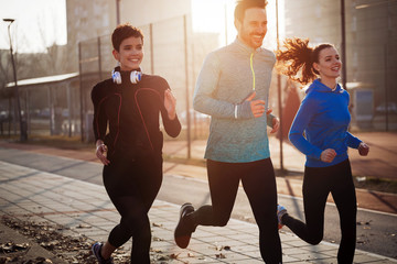 Canvas Print - Friends fitness training together outdoors living active healthy lifestyle