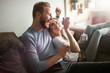 © NDABCREATIVITY - Romantic couple eating ice cream together and watching tv