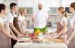© Africa Studio - Male chef and group of people at cooking classes