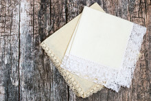 Handkerchiefs.   Two Handkerchiefs With Lace Trim On An Old Wooden Background.