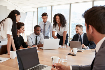 Group Of Businesspeople Meeting Around Table In Office