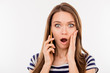 Close up portrait of shocked woman talking to somebody on the phone