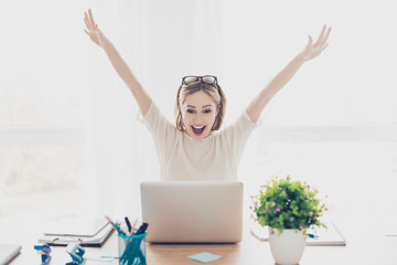 happy excited successful businesswoman triumphing with laptop