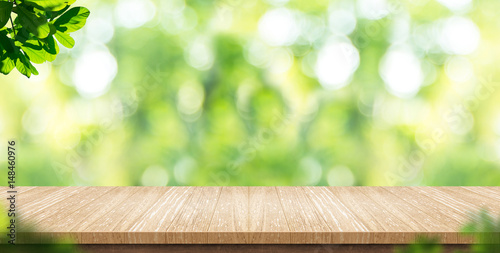 Fotografía Empty wood plank table top with blur park green nature background bokeh light,Mo