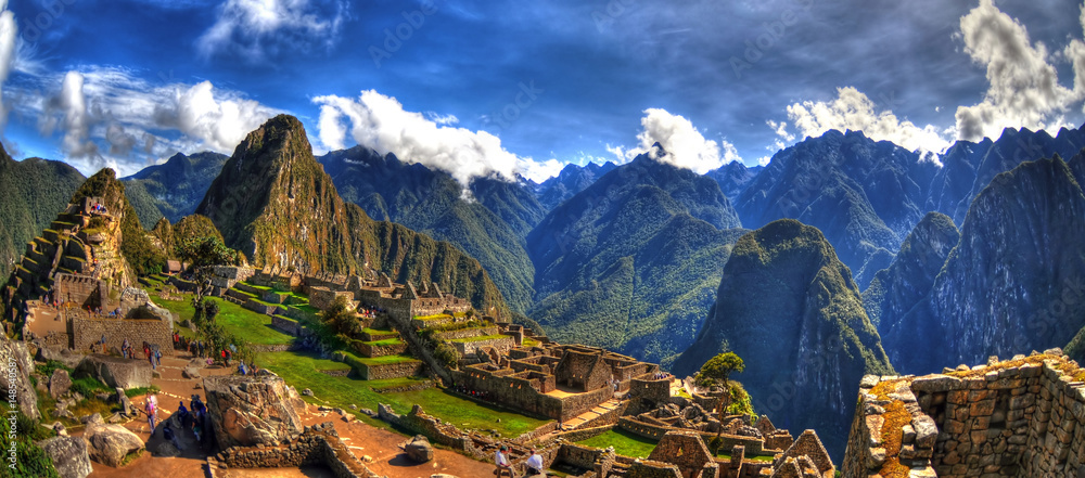 Colorful panoramic HDR image of Machu Picchu, Peru, South America - the lost city of the Inca on blue sky. Machu Picchu is UNESCO World Heritage Site, and One of the New Seven Wonders of the World. - obrazy, fototapety, plakaty 