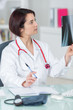 © auremar - image of attractive woman doctor looking at x-ray results