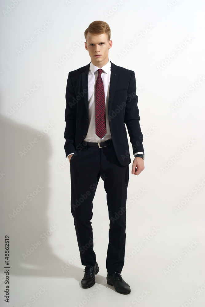 Young handsome man with red hair in black classical formal suit, white ...