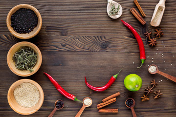 Dry colorful spices, chili pepper on kitchen wooden table background top view mockup