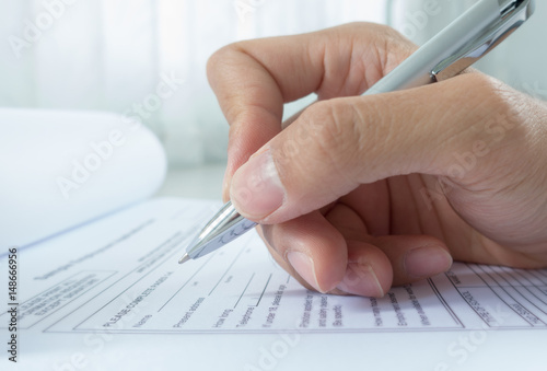 Fotografie, Obraz Hand with pen over application form, Filling name in personal details
